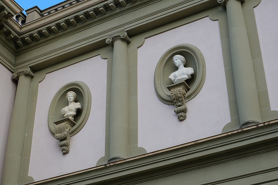 Busts of great men in round niches on the facade of the Musée Ariana