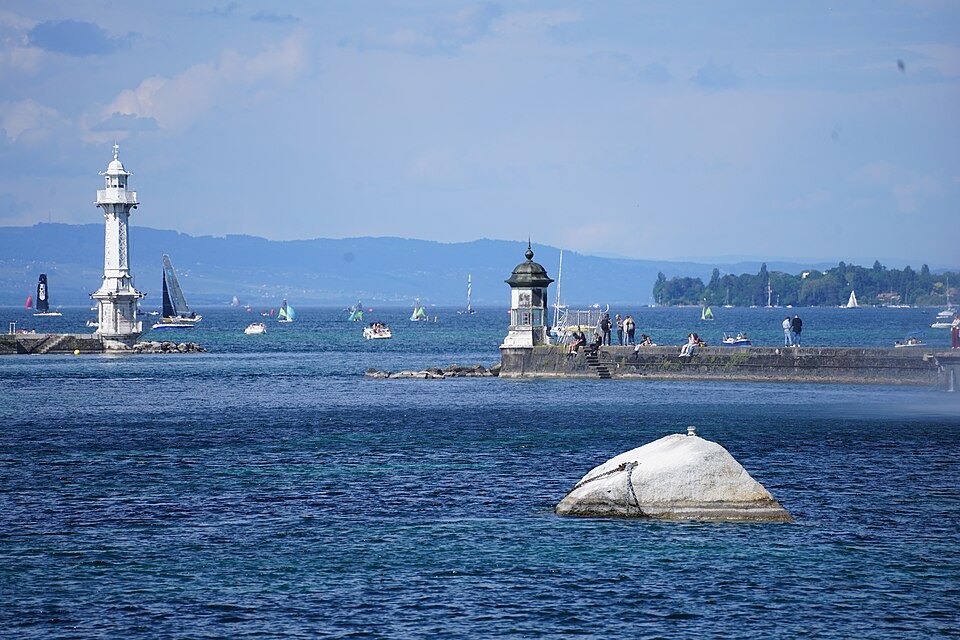 The Pierres du Niton offshore with both harbor lighthouses and sailboats beyond