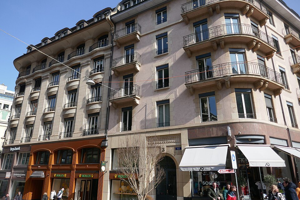 Balconied apartment houses with shopfronts and awnings on the Rue de la Fontaine