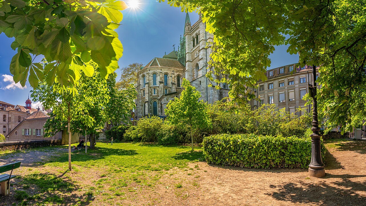 The cathedral's apse and spire seen from a leafy garden in the old town