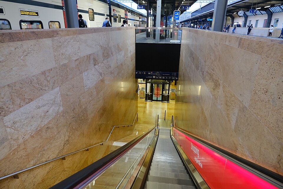 An escalator descending between marble walls at Cornavin station