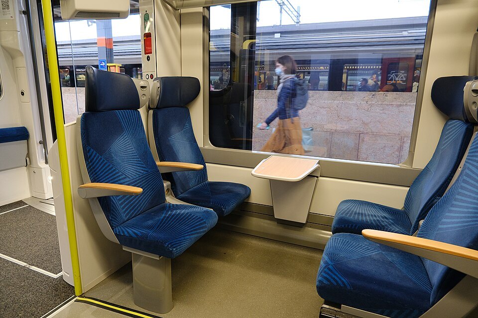 Blue seats inside a Léman Express train standing at Cornavin