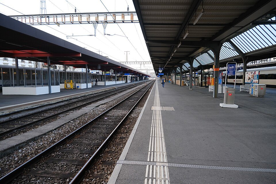 An empty platform and tracks under the canopies of Cornavin station