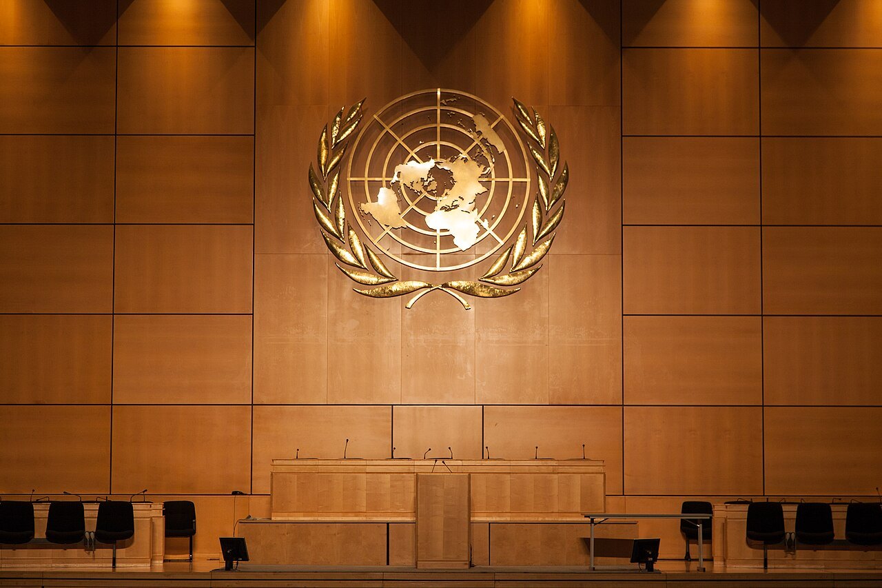 The United Nations emblem on the wooden wall of the Assembly Hall in the Palace of Nations