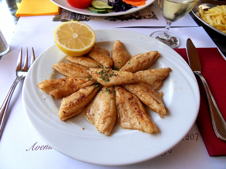 A plate of golden perch fillets from the lake with lemon