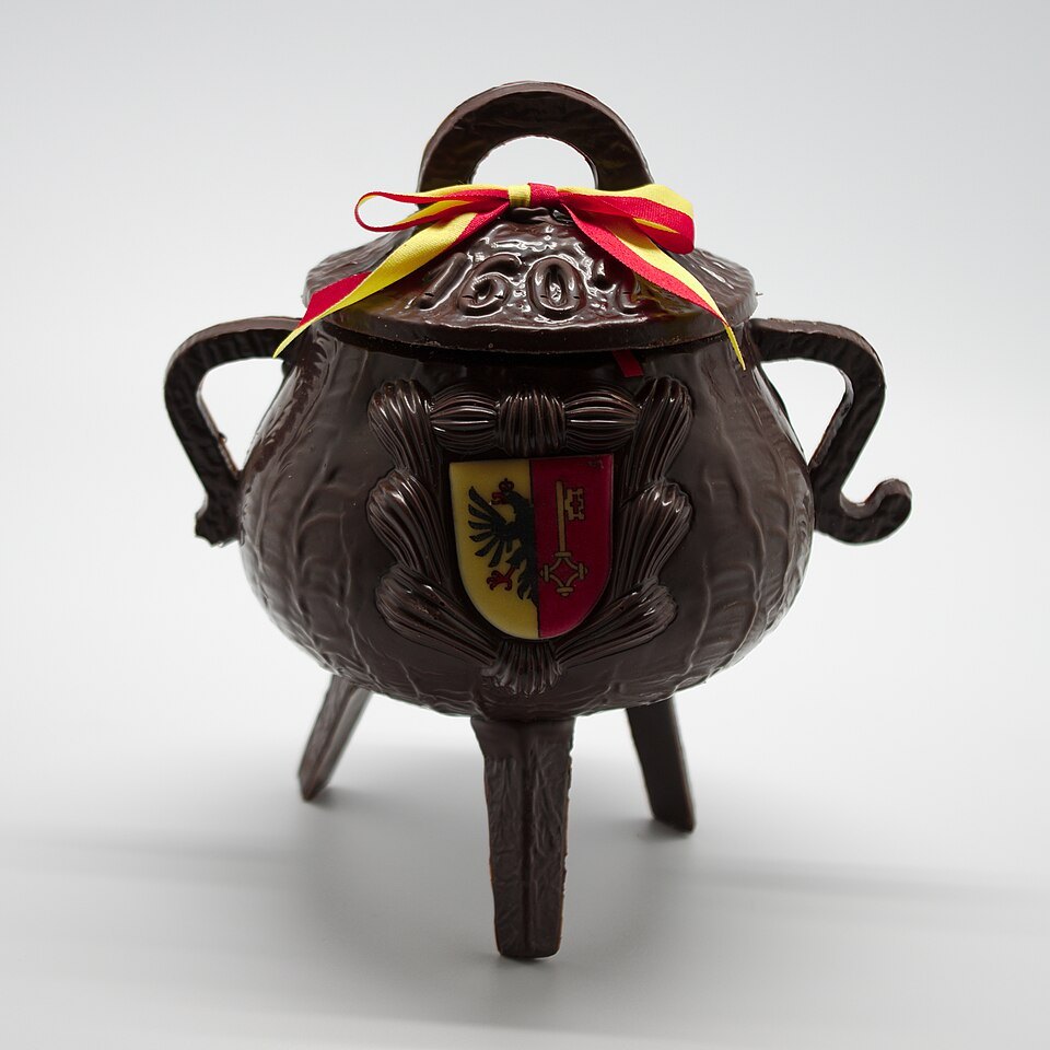 A chocolate Escalade marmite with Geneva's arms and a red and yellow ribbon