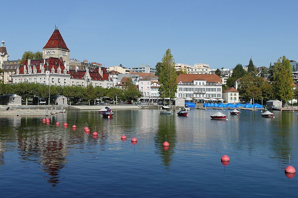 The Château d'Ouchy and the Lausanne waterfront reflected in the harbor