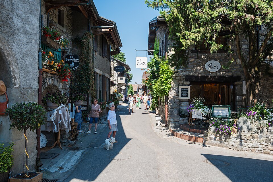 Flowers and shop signs along the main street of Yvoire's medieval village