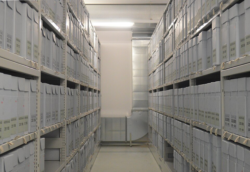Rows of archive boxes on shelves in the Red Cross public archives