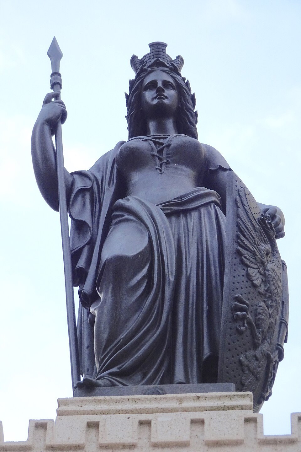A bronze statue of Geneva with spear and shield atop the Escalade fountain