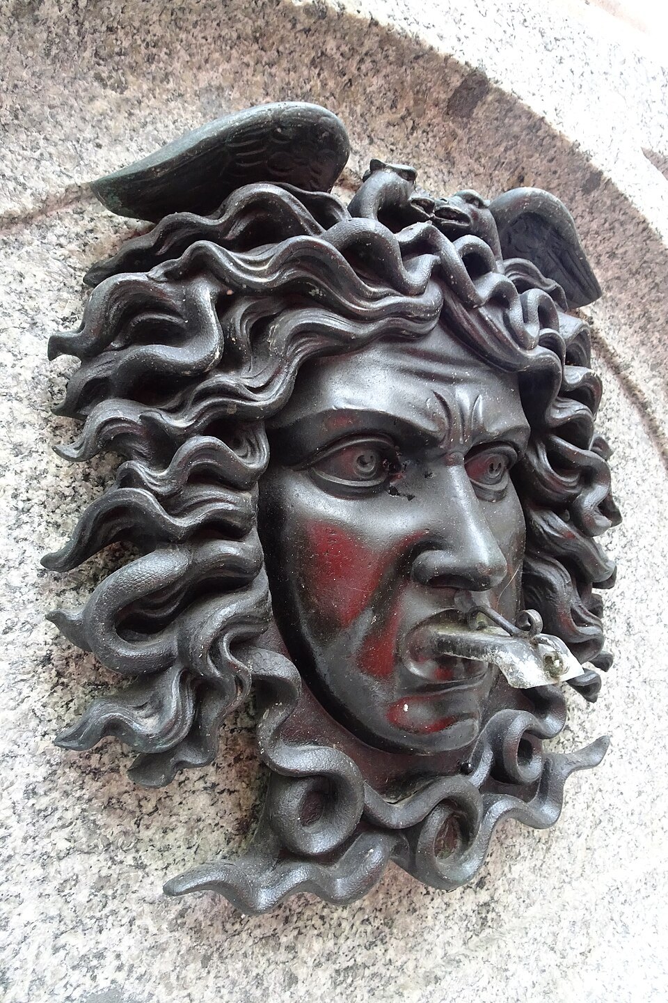 A gorgon's head carved on the Escalade fountain