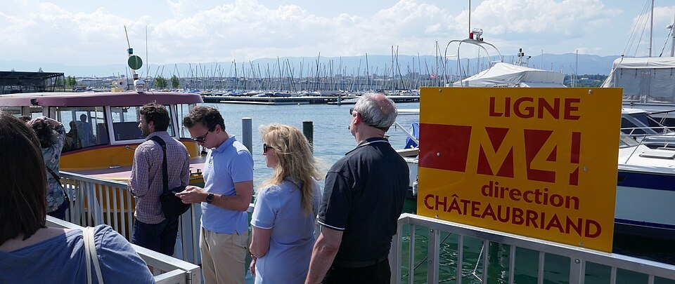 Passengers waiting by the M4 sign at a Mouettes landing