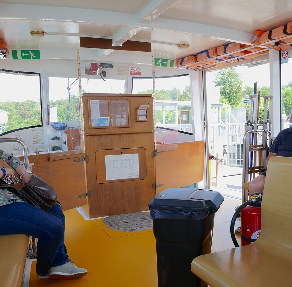 Inside a Mouette water bus, its wooden benches and cabin