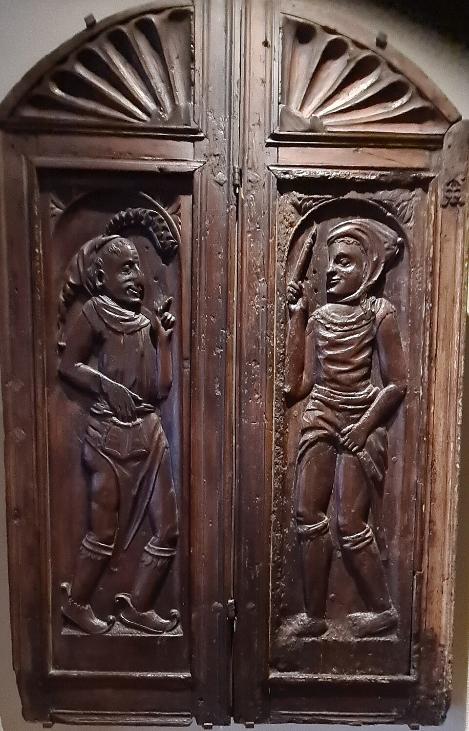 Carved wooden shutters with two figures, kept from an old house in the old town