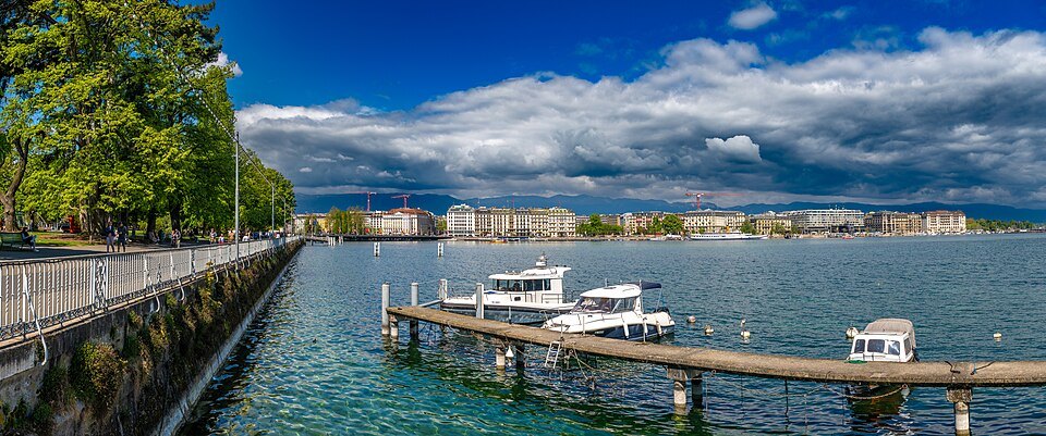 A private pier and boats along the lakefront wall on a cloudy summer day