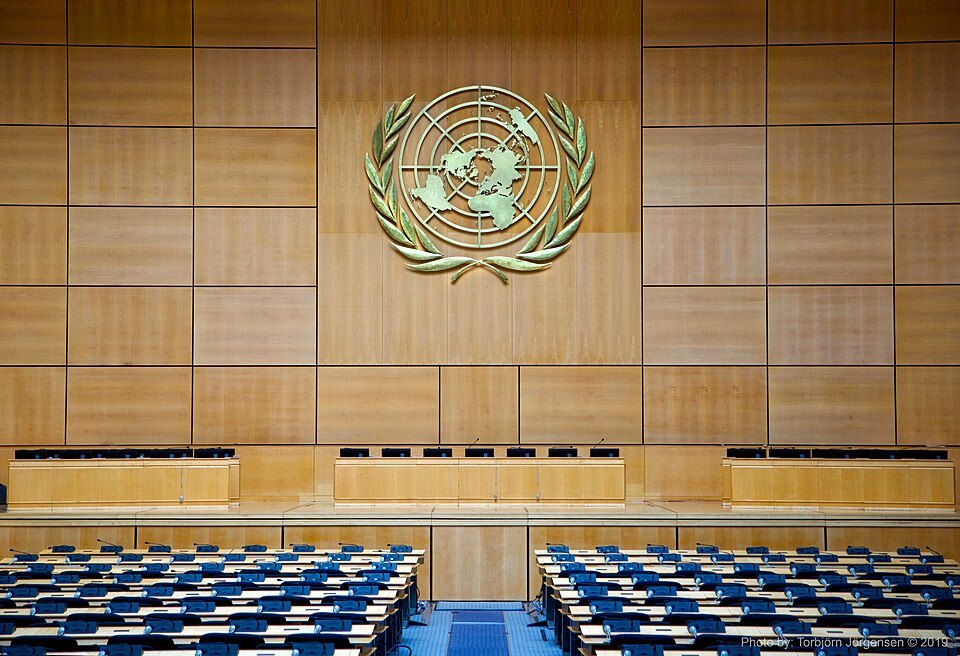 The United Nations emblem above the rows of seats in the Assembly Hall
