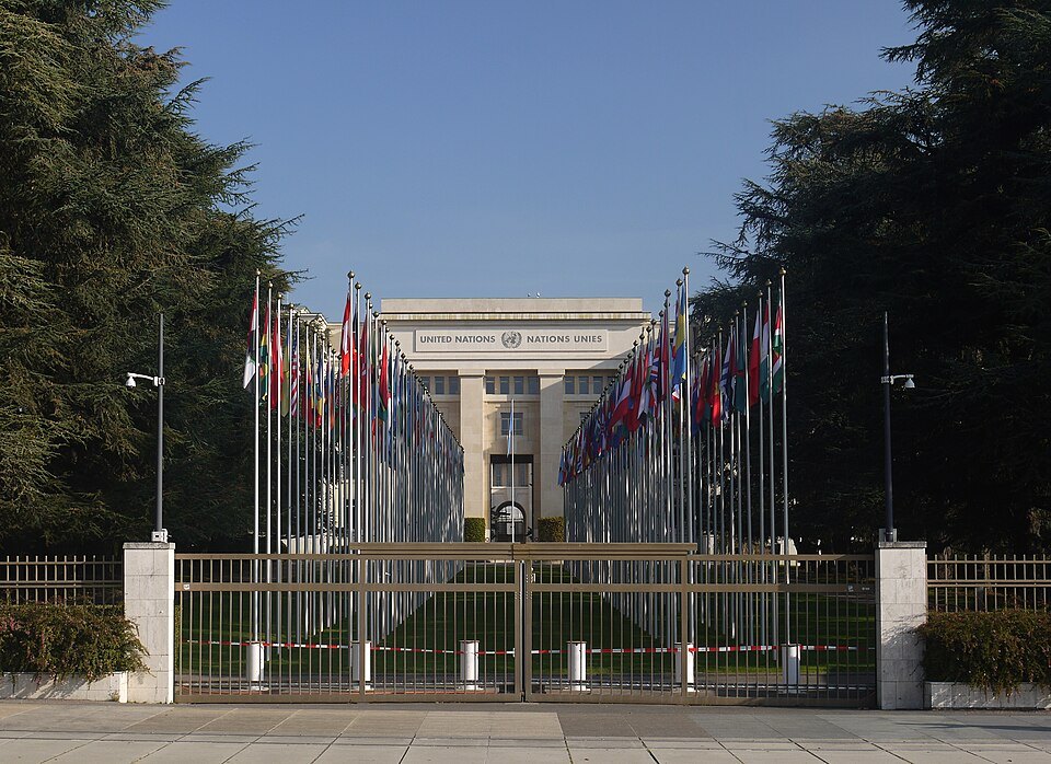 The avenue of flags seen through the gates of the Palace of Nations