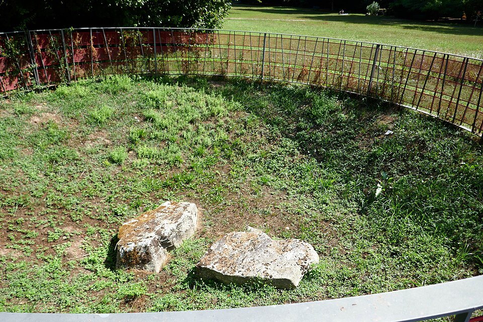 Two fallen menhirs lying in the grass of Parc La Grange