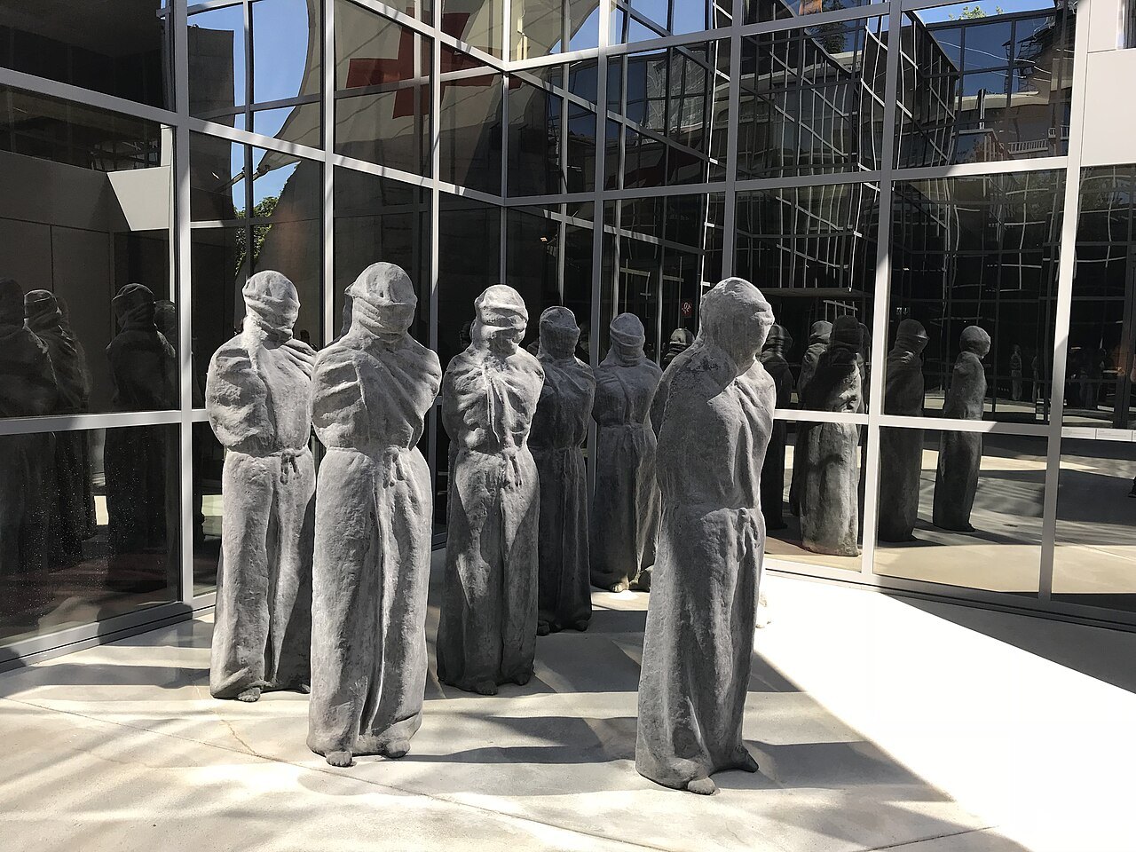 Carl Bucher's hooded stone figures, Les Pétrifiés, at the museum entrance