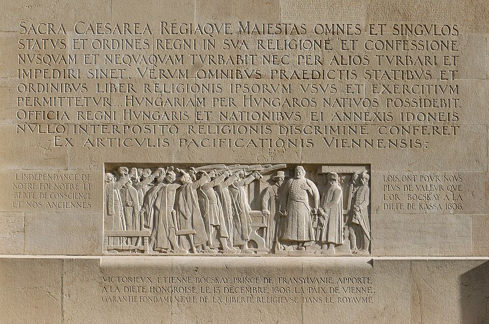 A carved relief and Latin inscription recalling the 1606 Treaty of Vienna on the Wall
