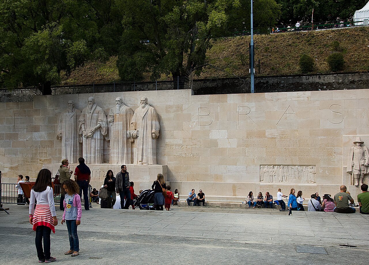 Families sitting on the steps below the Reformation Wall