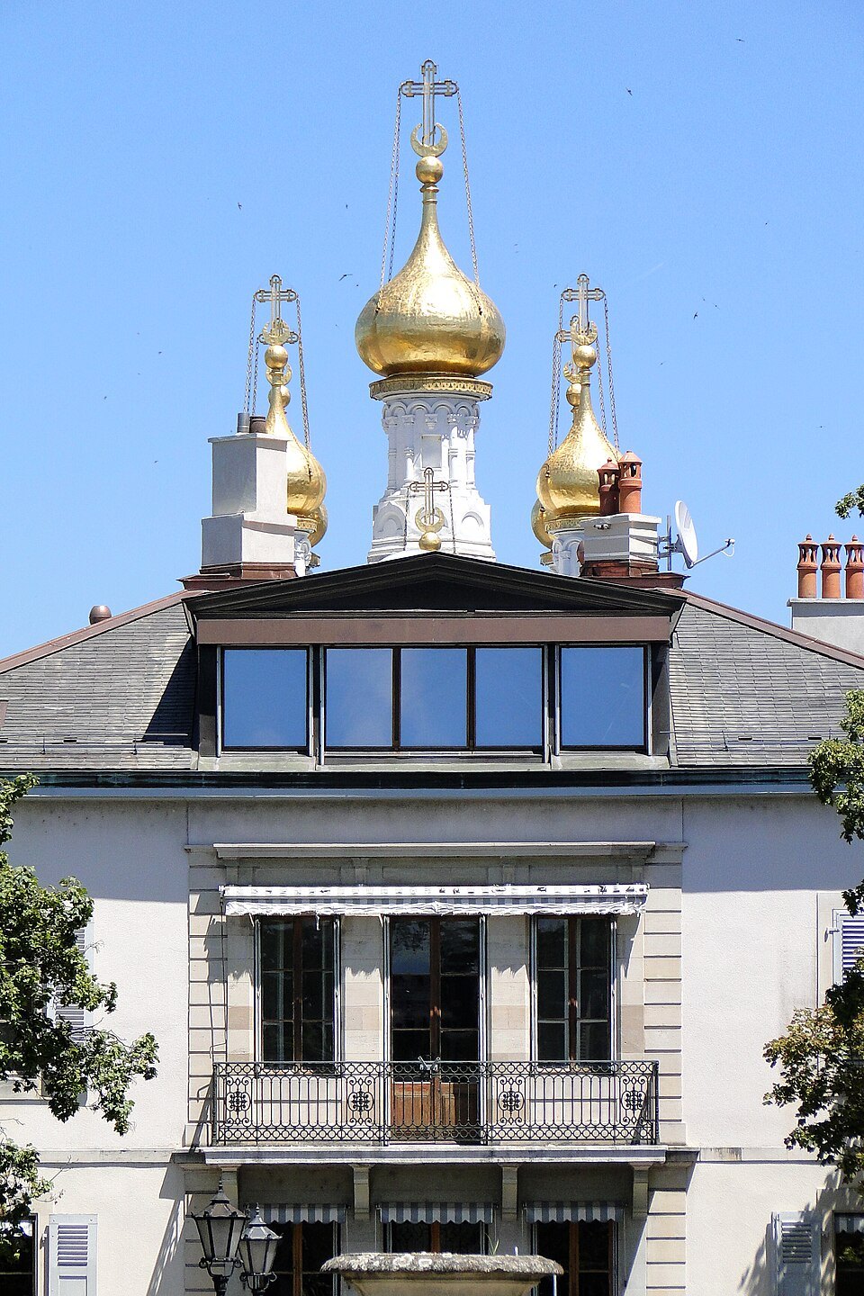 Gilded domes of the Russian Church rising behind an old town house
